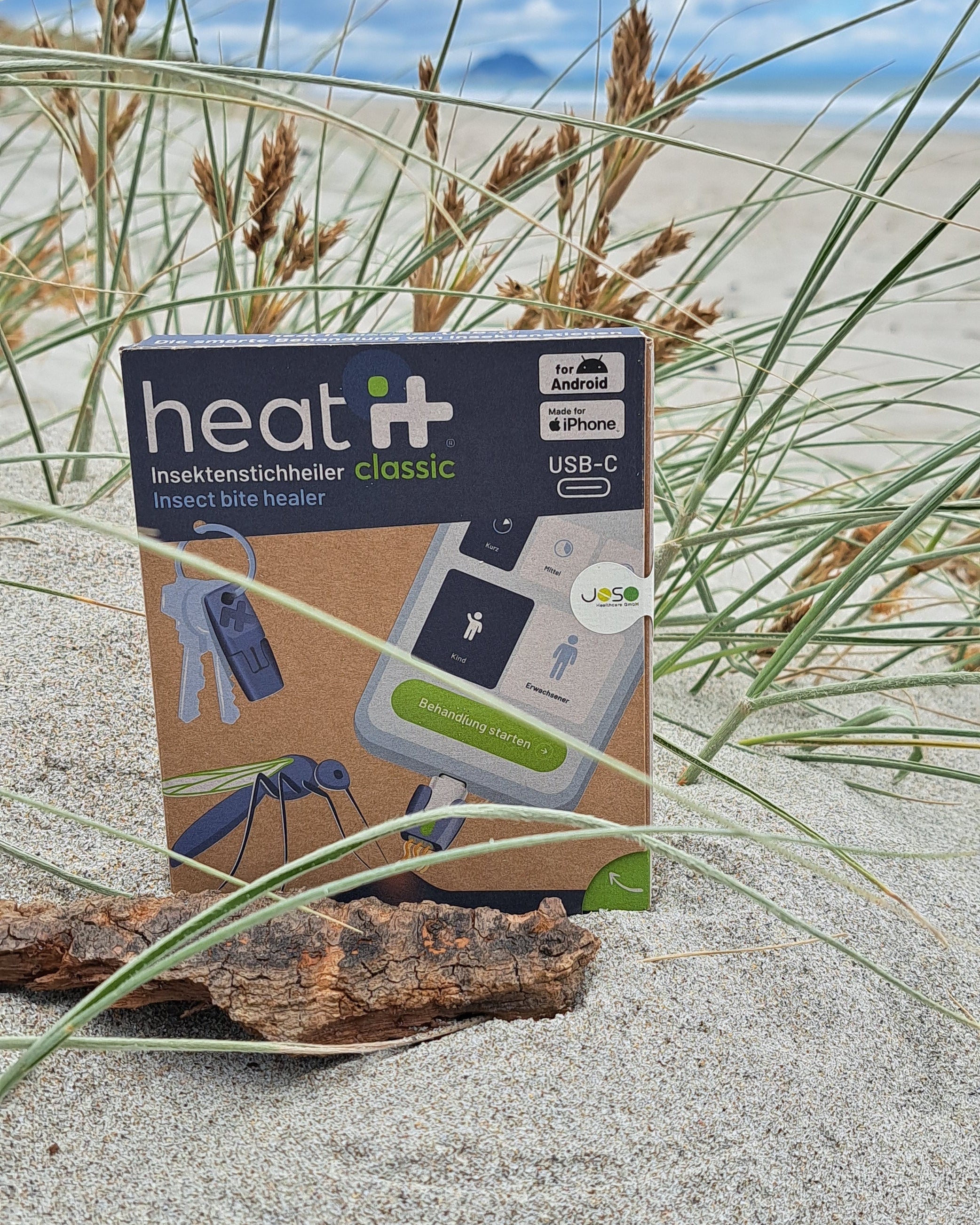 heat it® Classic insect bite healer packaging on sand dunes at Papamoa Beach, with Mount Maunganui in the background, New Zealand